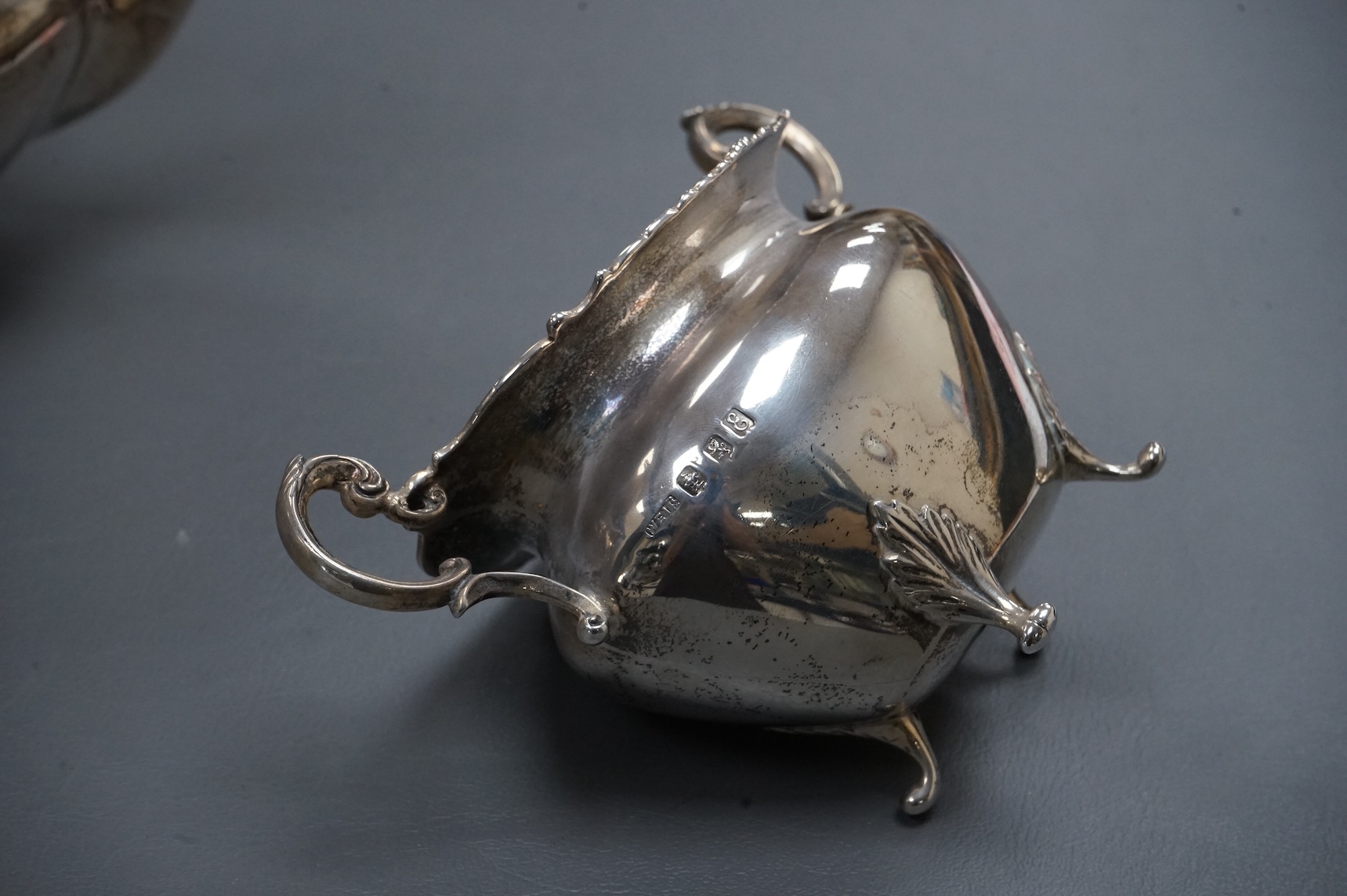 An Edwardian Scottish silver three piece oval tea set by Weir & Sons, Glasgow, 1901, gross 25.5oz, with foliate borders.